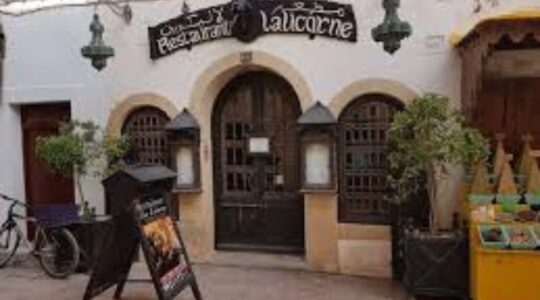 Candlelit stone vault interior of La Licorne for prestigious Medina dining Essaouira